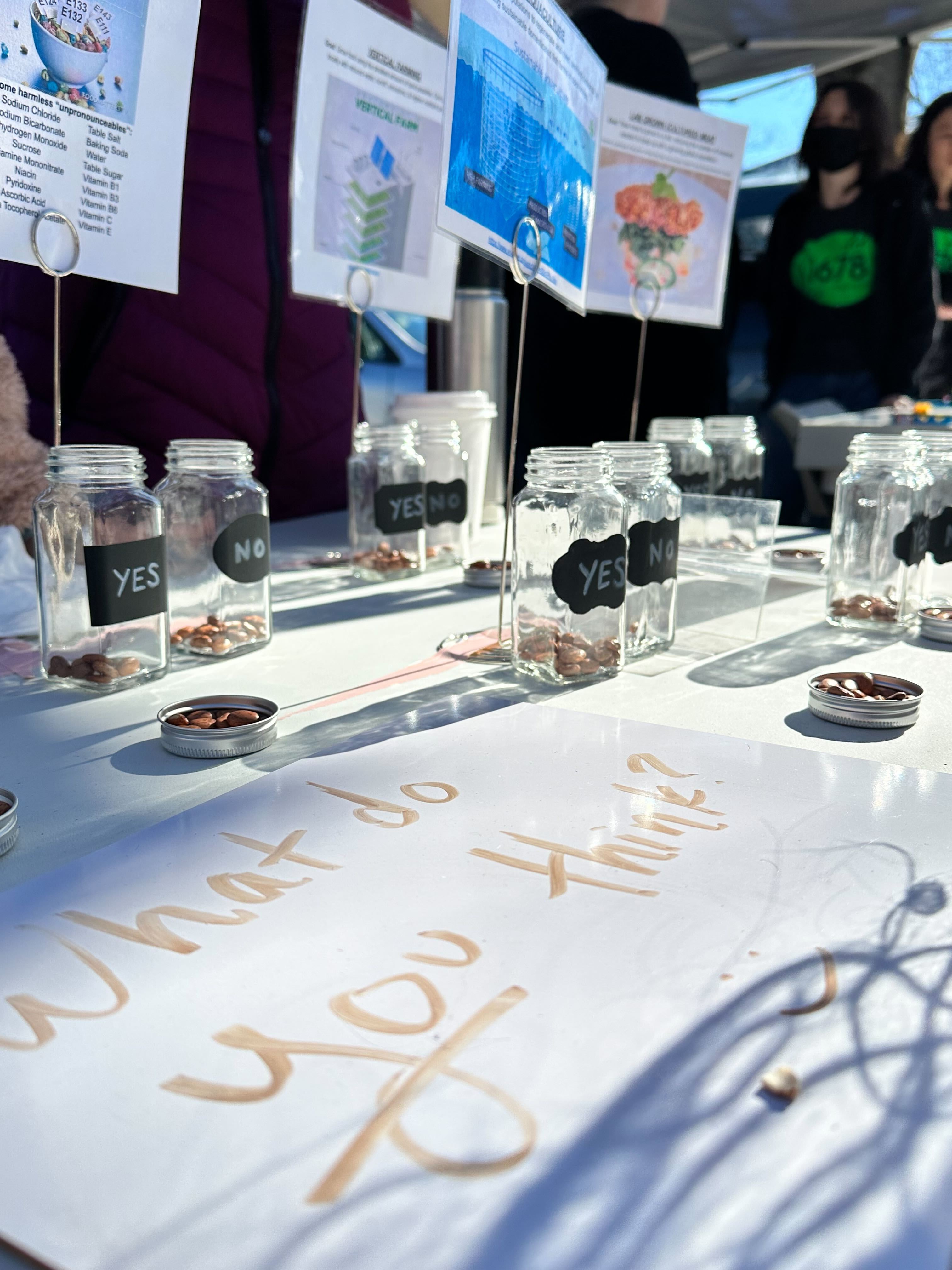 Table display featuring spice jars with beans and signs