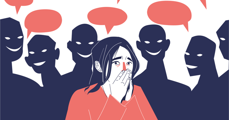 Cartoon image of social anxiety. A person in the middle is showing social anxiety symptoms (covering their mouth, flushed cheeks) while people in the background are conversing. The person in the middle assumes the conversation is about them.