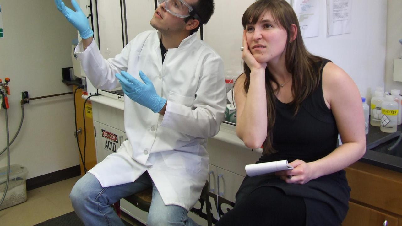 Scientist talking to bored person