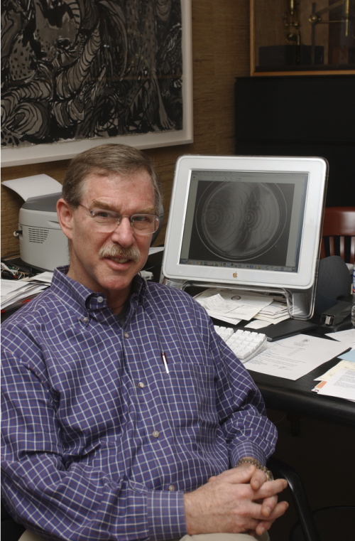 Color photo of Dr. James Shapiro in front of an old computer.