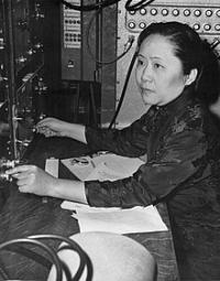 Black and white photograph of Dr. Chiein-Shiung Wu at a large piece of electrical equipment
