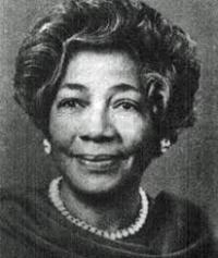 Dr. Angie Turner King, in a dark colored top and pearl necklace. The picture is in black-and-white.