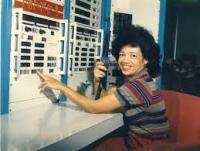 Color photograph of Dr. Christine Darden at an old computer machine.