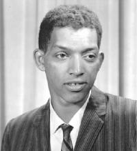 Black-and-white photograph of Dr. George Robert Carruthers. He is wearing a striped suit and tie.