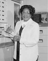 Black and white photograph of Mary Jackson working with a notebook