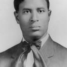 Black-and-white photograph of Garrett Morgan. He is dressed in a suit and tie and looking off to the right of the camera.